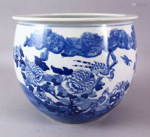 A CHINESE BLUE AND WHITE JARDINIERE, painted with birds amongst native flora, 23cm high, 28cm