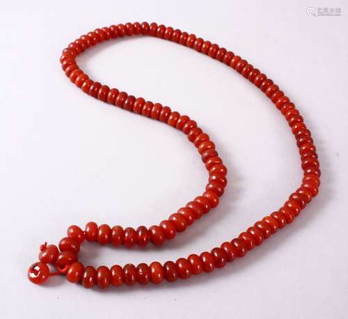 A CHINESE AGATE BEAD NECKLACE, the bead approx 8mm diameter.