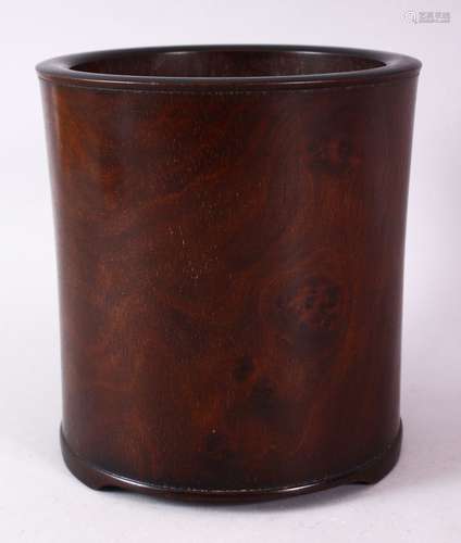 A CHINESE BURR WOOD BRUSH POT, of plain design, on three bracket feet, 16cm high.