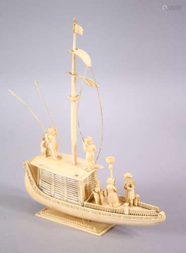 A FINELY CARVED 19TH CENTURY INDIAN IVORY BOAT WITH FISHERMEN, with fine strands of sails, six