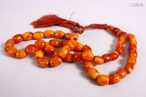 A 19TH CENTURY ISLAMIC CARVED AMBER PRAYER BEAD NECKLACE, with 46 carved beads, and three spacers,