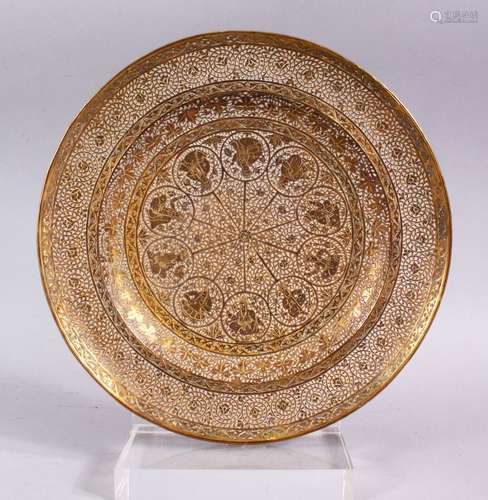 A GOOD INDIAN PIERCED GILDED WHITE METAL CIRCULAR DISH, 23cm diameter.