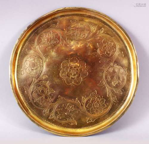 A 19TH CENTURY OTTOMAN GILDED COPPER TOMBAK TRAY, the centre engraved with a flowerhead design