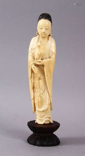 A GOOD 18TH / 19TH CENTURY CARVED IVORY FIGURE OF GUANYIN, stood holding a vessel and rosary