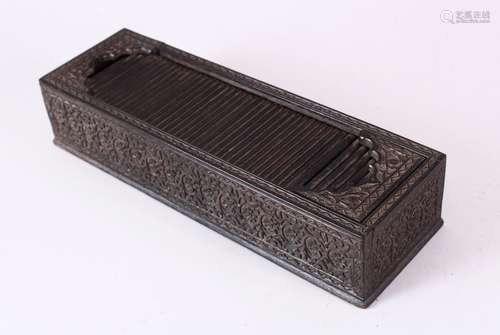 A GOOD 19TH CENTURY INDIAN CARVED EBONY RECTANGULAR PEN BOX, with tambour cover, the sides finely