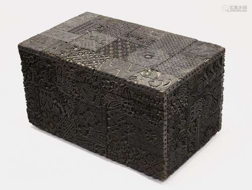 A HIGHLY UNUSUAL RECTANGULAR HINGED BOX, constructed from numerous carved hardwood printing