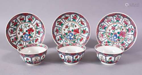 A GOOD SET OF THREE CHINESE FAMILLE ROSE TEA BOWLS AND SAUCERS.