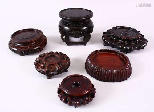 A LOT OF 6 19TH CENTURY CHINESE CARVED HARDWOOD STANDS, each of varying size and shape, three of the