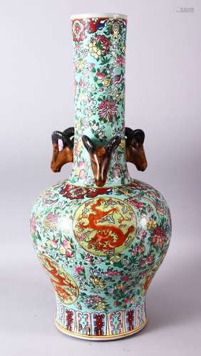 A LARGE CHINESE FAMILLE ROSE TRIPLE RAM HEAD PORCELAIN BOTTLE VASE, decorated with roundels of