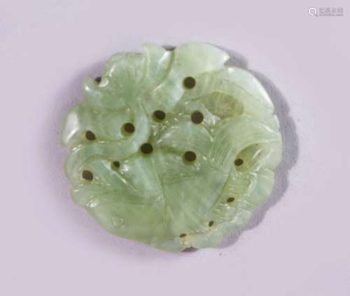 A 19TH CENTURY CHINESE PIERCED AND CARVED JADE ROUNDEL, with carved fish, 5cm.