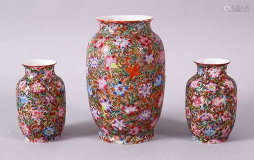 A GARNITURE OF THREE SMALL 19TH/20TH CENTURY CHINESE MILLIFLEUR VASES, the bodies decorated with the