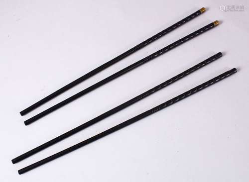 TWO PAIRS OF CHINESE CARVED EBONY CHOPSTICKS, each carved and one set with metal tops, both 29cm.