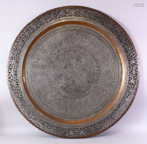 A MONUMENTAL INDIAN ENGRAVED METAL TRAY, with pierced border, 98cm diameter.