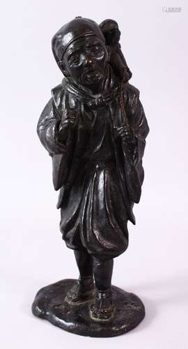 A GOOD 19TH CENTURY JAPANESE BRONZE FIGURE OF A MAN, a monkey on his back, 33cm high.