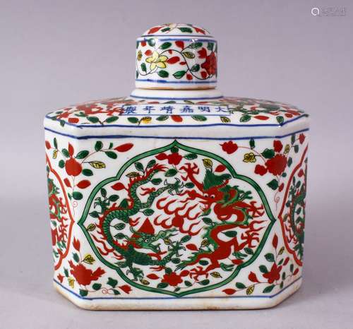 A CHINESE WUCAI DECORATED PORCELAIN TEA CADDY & COVER, decorated with panels of dragons and flora,