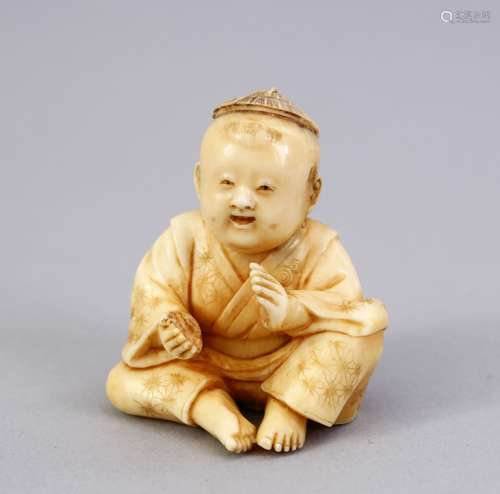 A JAPANESE MEIJI PERIOD CARVED IVORY NETSUKE OF A BOY, the boy in a seated position clapping his