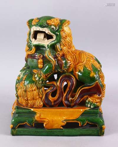 A GOOD CHINESE SANCAI GLAZED POTTERY FIGURE OF A LION DOG, the dog with its paws upon a pup,