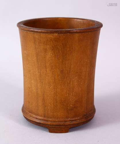 A PLAIN 18TH CENTURY CHINESE BRUSH POT, on three bracket feet, 11cm high.