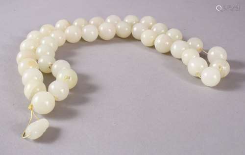 A GOOD SET OF CHINESE CARVED WHITE JADE BEAD NECKLACE, comprising 37 carved beads and a toggle,