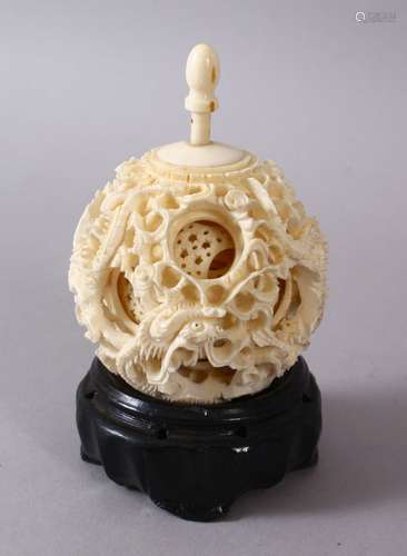 A 19TH CENTURY CHINESE CANTON CARVED IVORY PUZZLE BALL, carved with scenes of a dragon with its