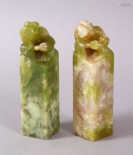 TWO GOOD CHINESE CARVED JADE OR JADE LIKE HARDSTONE LION DOG SEALS, the bases carved, the tops