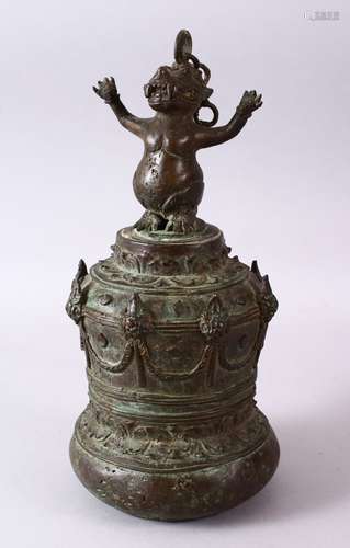 AN EARLY INDONESIAN BRONZE TEMPLE BELL, the top with a mythical beast finial and hanging chain,