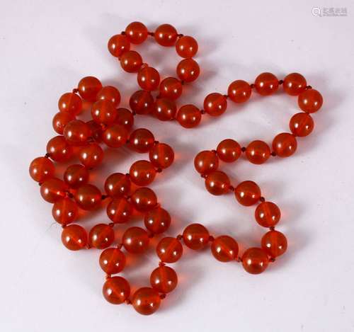 A 19TH CENTURY SET OF CARVED AMBER PRAYER BEADS, in the form of a necklace, comprising 50