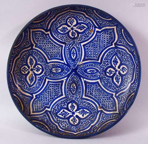 A 19TH CENTURY IZNIK POTTERY DISH, with four quatrefoil panels, 36cm diameter.