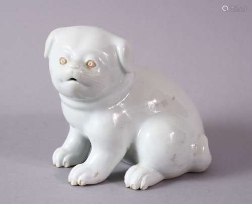 A 19TH CENTURY JAPANESE HIRADO PORCELAIN MODEL OF A PUPPY in a seated pose, 10cm high, 13cm wide.