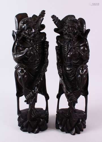 A LARGE PAIR OF 19TH CENTURY CHINESE SILVER COLOUR WIRE INLAID FIGURES OF SAGES, the mirrored pair