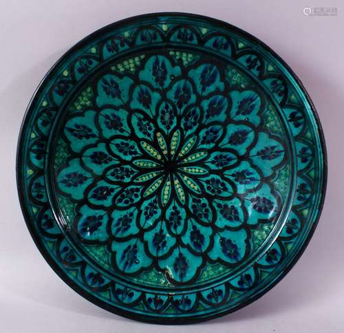 A 20TH CENTURY IZNIK POTTERY CIRCULAR BOWL, green ground painted with flower head design, 39cm