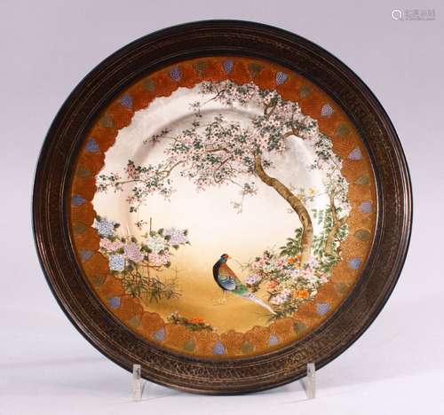 A JAPANESE MEIJI PERIOD SATSUMA SILVER MOUNTED PLATE, the plate encapsulated with a solid silver