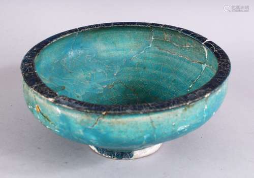 AN EARLY PERSIAN OTTOMAN TURQUOISE GLAZED POTTERY BOWL (repairs and restoration), 19cm diameter.