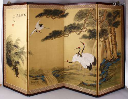 A CHINESE PAINTED SILK TEXTILE FOUR FOLD DIVIDING SCREEN, painted to depict four cranes aside a