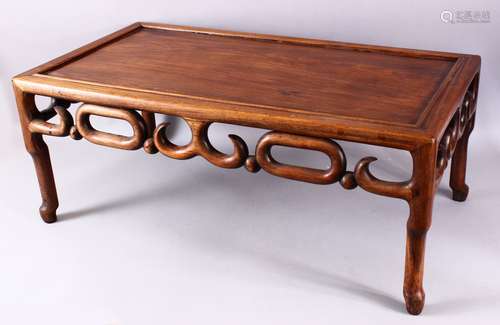 A 19TH CENTURY CHINESE CARVED HARDWOOD OPIUM TABLE, with simplistically carved frieze stood upon