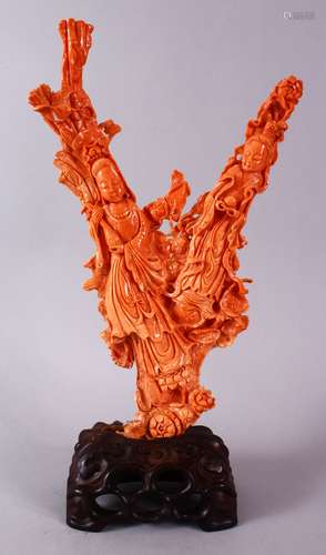 A 19TH CENTURY CHINESE CARVED CORAL FIGURE OF GUANYIN, the carving of natural graduating red colour,