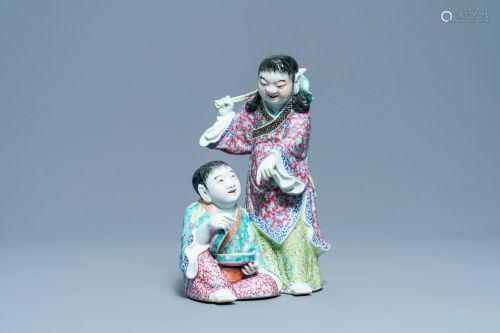 A Chinese famille rose group of two boys with a bat,