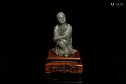 A Chinese Shoushan soapstone figure of a seated man,