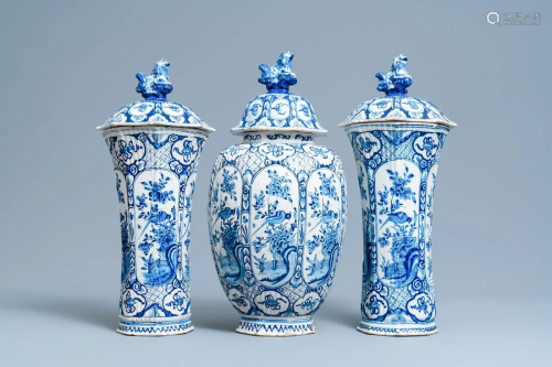 A Dutch Delft blue and white garniture of three vases