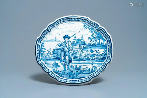 A Dutch Delft blue and white plaque with a hunter, 18th
