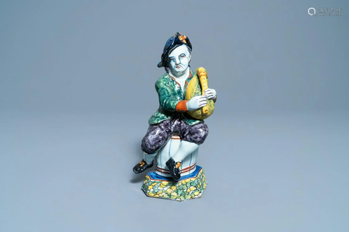 A polychrome Dutch Delft figure of a bagpipe player,