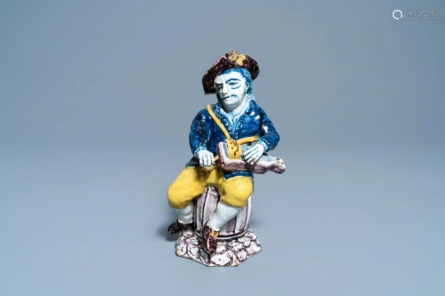 A polychrome Dutch Delft figure of a hurdy-gurdy