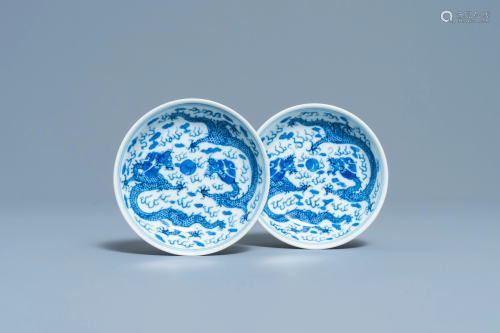 A pair of Chinese blue and white 'dragon' saucers,