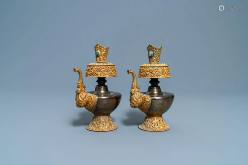 A pair of Tibetan silver and gilt copper alloy