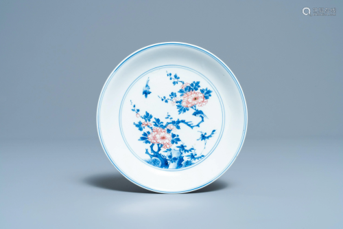 A Chinese blue, white and copper red saucer dish with