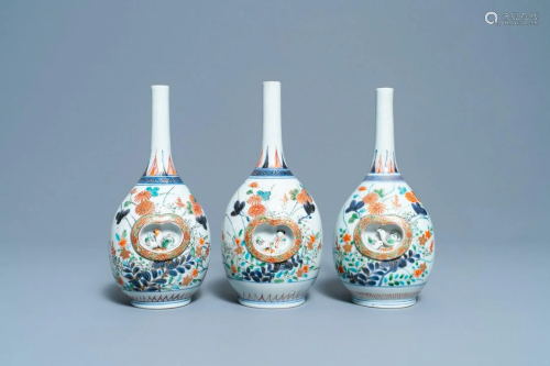 Three Japanese Imari bottle vases with molded panels,