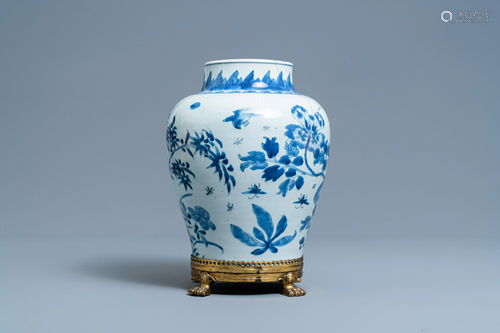 A Chinese blue and white vase on a gilt bronze foot,