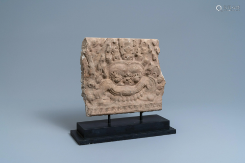 A Khmer-stye stone carving fragment with the head of