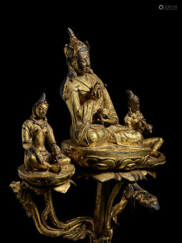 A GILT COPPER ALLOY TRIAD OF PADMASAMBHAVA AND HIS CONSORTS, MANDARAVA AND YESHE TSOGYAL TIBET, CIRCA 16TH CENTURY