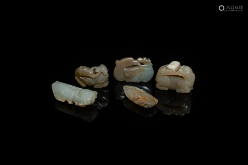 Five Chinese celadon and russet jade carvings, 19th C.